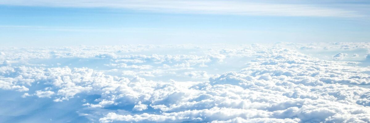 A view of clouds from above the cloud line; blue skies.