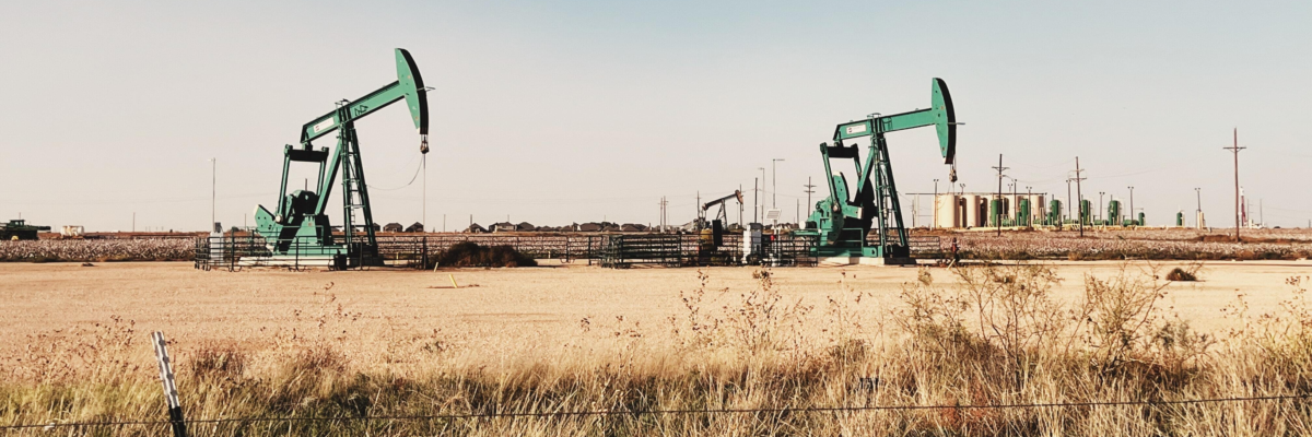 Two pump jacks mining crude oil in Midland, Texas.