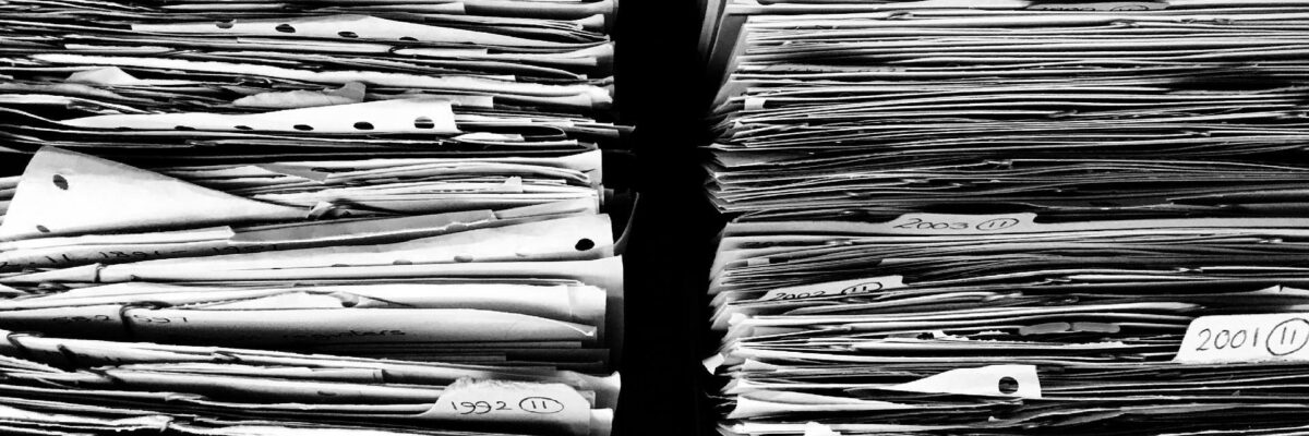 A black and white shot of two stacks of papers, taking up the whole frame.