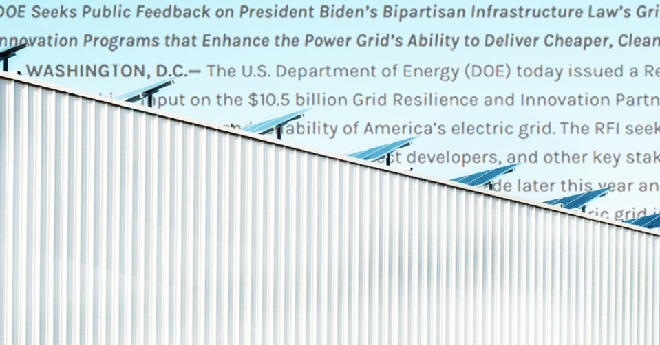 Solar panels on a building with corrugated metal siding; text from a Department of Energy press release sits in the sky behind the building