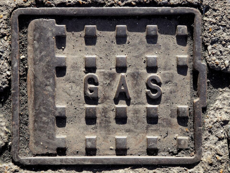 A grate cover on the ground that says "GAS"