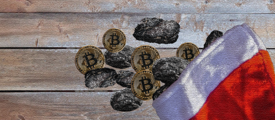 A Christmas stocking, filled with coal and gold coins with the Bitcoin symbol on them.