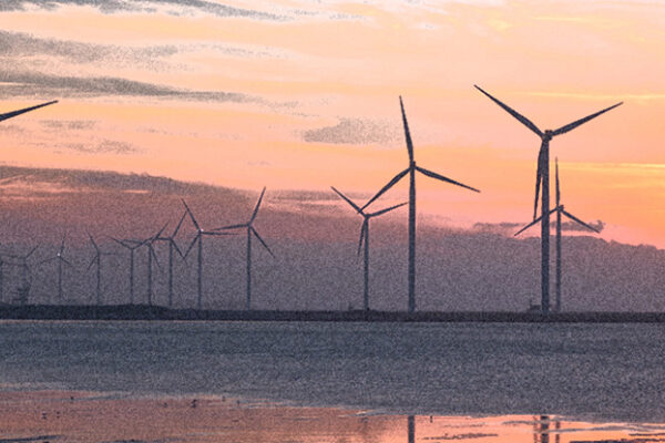 Offshore wind turbines at sunset.