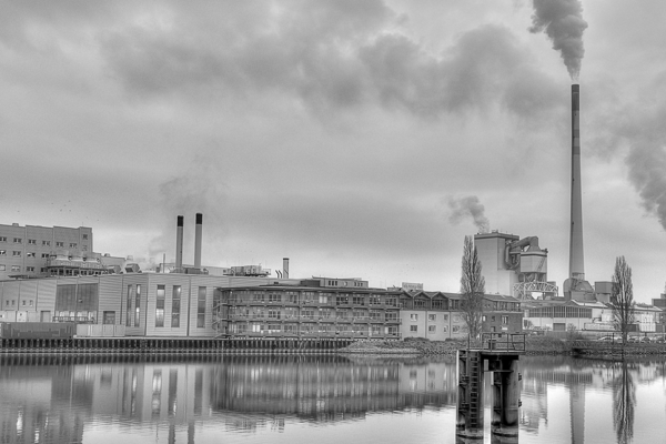 black and white smoke stacks and factory