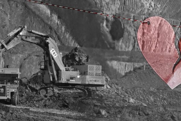 A construction vehicle at a mining site; a broken heart.