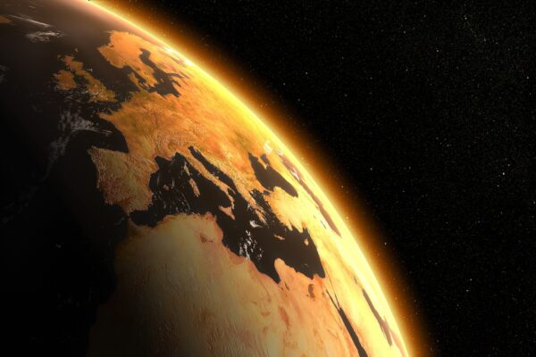 A partial view of planet earth, viewed from space, shrouded in an ominous orange glow
