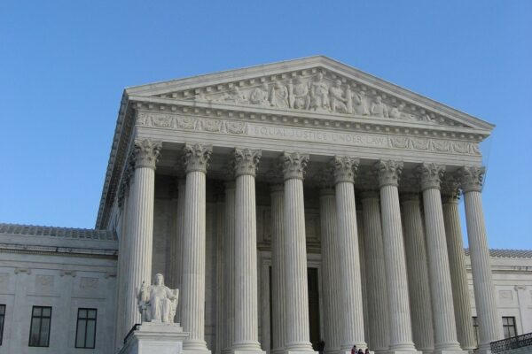 The Supreme Court building during the day; a blue sky in the background.