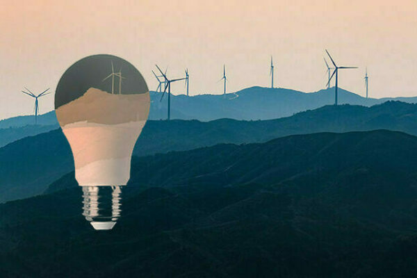 An illustration of a lightbulb and rolling hills dotted with wind turbines
