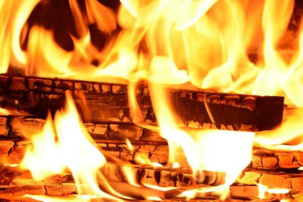 A close up shot of a fire using wooden logs.