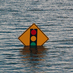 A traffic signal sign sticking out of flood waters