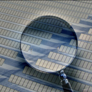 A magnifying glass superimposed on an aerial view of a solar farm